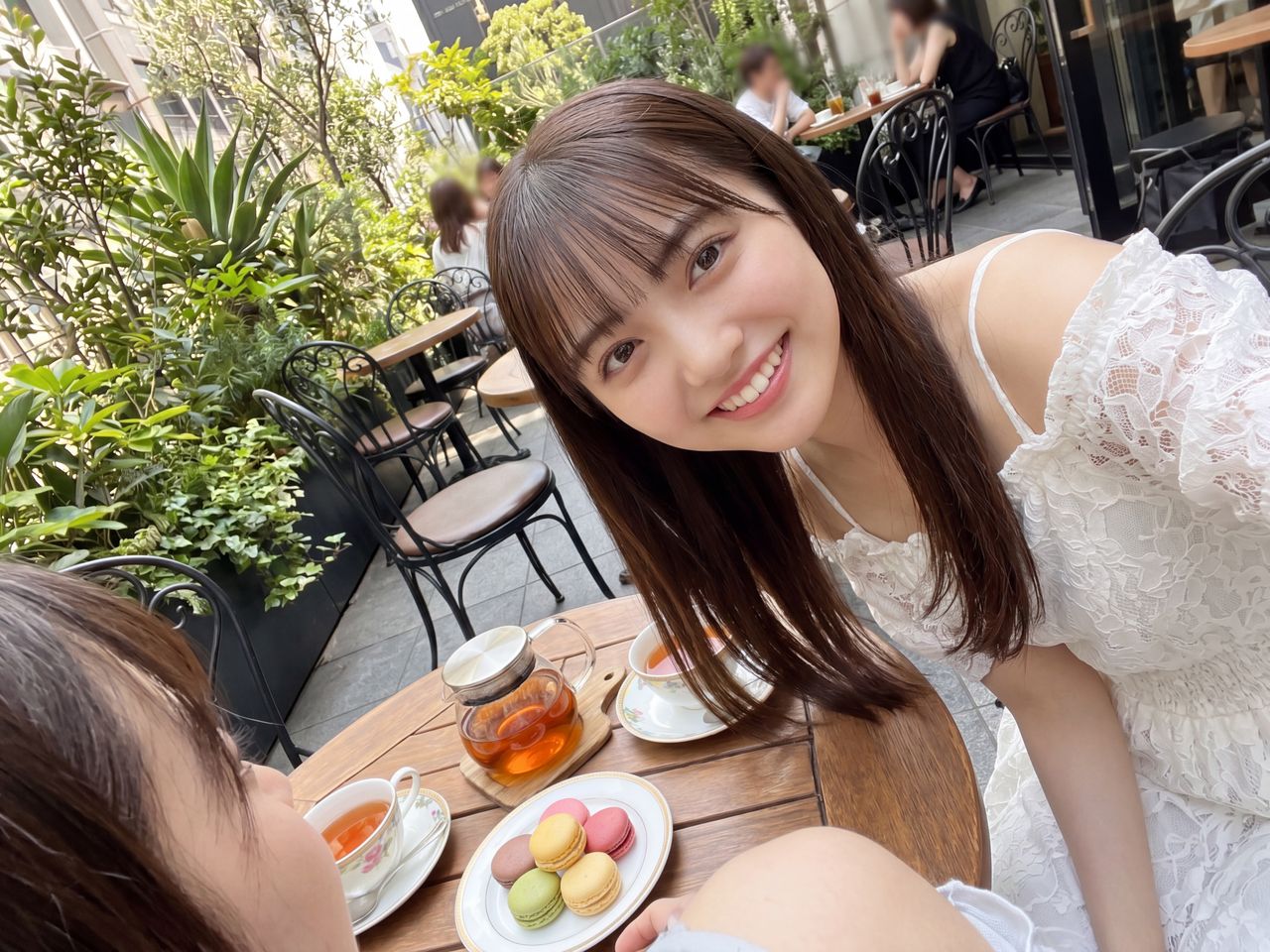 カフェテラスでマカロンを楽しむ如月玲奈